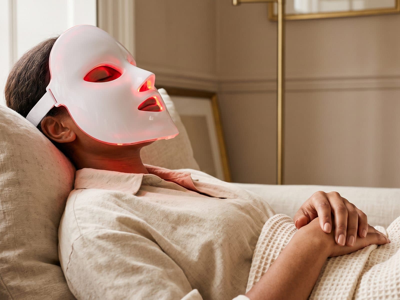 Wearing an LED face mask with eyes closed during a session Wearing an LED face mask with eyes closed during a session